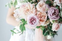 a pastel wedding bouquet of peachy and lilac blooms plus greenery is a chic and tender idea for a soft look