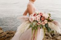 a pastel wedding bouquet with blush roses, pampas grass and king proteas will make a statement