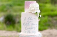 a pastel wedding cake with a pink and dusty blue ruffle tier, a love letter tier and a white bloom is a chic idea for a spring wedding