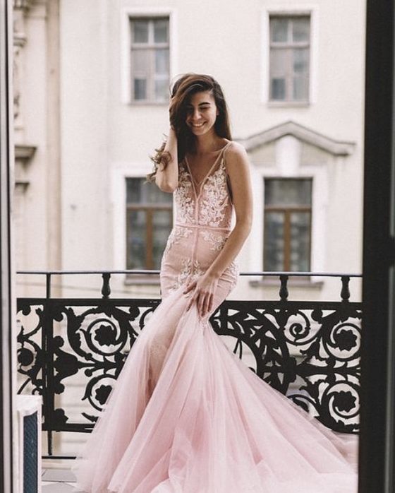 a pink mermaid wedding dress with thick straps, a train and white lace appliques foor a trendy feel