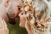 a pretty dried flower crown with yellow, neutral and rust dried blooms, leaves and feathers is a great idea for a fall boho bride