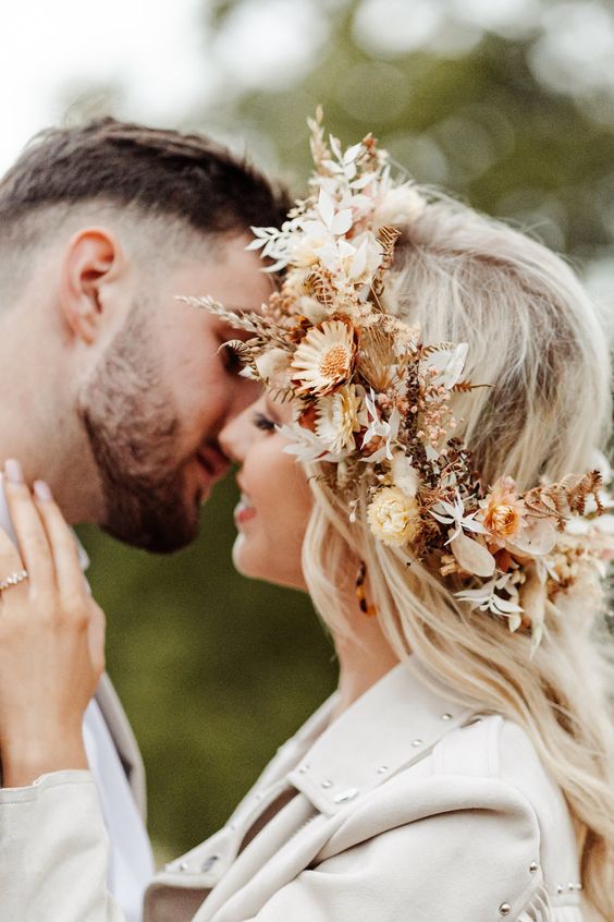 a pretty dried flower crown with yellow, neutral and rust dried blooms, leaves and feathers is a great idea for a fall boho bride