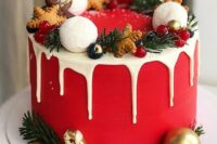 a red wedding cake with creamy drip, gingerbread cookies, ornaments, evergreens and berries is a lovely idea for a winter celebration
