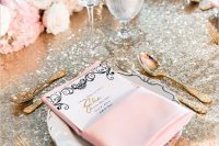 a silver tablecloth, pink napkins, a menu, blush and white blooms, gold cutlery and candles are lovely for a glam tablescape