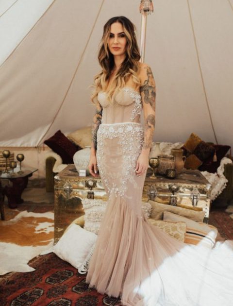 a strapless dusty pink heavily embellished mermaid wedding dress with a train looks spectacular