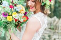 a super bold flower crown with orange, fuchsia and red blooms and different greenery is amazing for a summer bride
