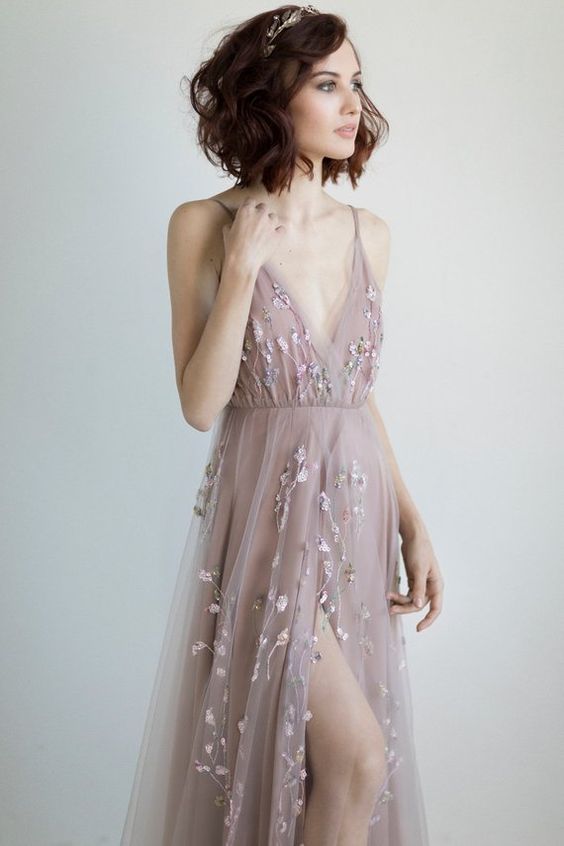 a super delicate dusty pink A-line wedding dress with pastel floral embroidery and a deep V-neckline is a dreamy idea to rock