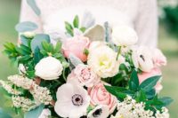 a textural wedding bouquet with pink and white roses, white anemones, greenery and some little blooms