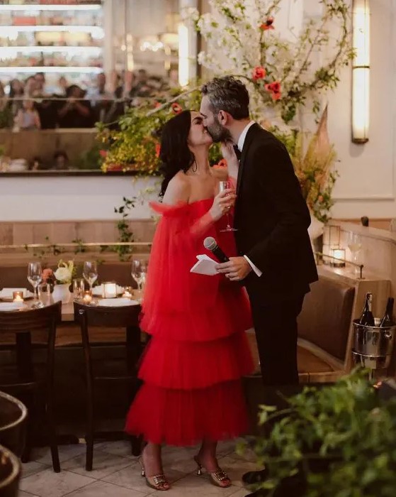 a unique off the shoulder red tea length wedding dress with a tiered skirt and long wide sleeves is a fantastic idea to stand out