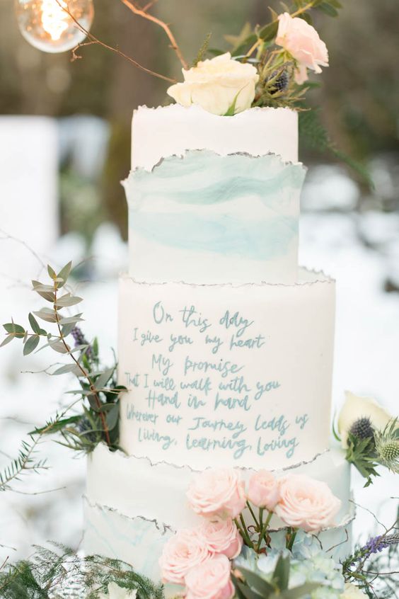 a white and blue marble wedding cake with a raw edge, fresh neutral and blush blooms and greenery for a spring wedding