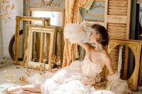 an haute couture bridal look with a blush strapless wedding dress with an applique bodice, a tulle skirt and additional sleeves plus lace shoes
