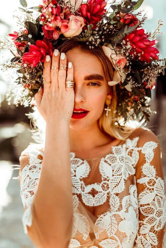 an oversized floral crown with blush, red and white blooms and textural greenery for a fall boho bride