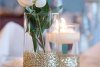 vases and candleholders accented with gold glitter will give a shiny touch and a cool look to your wedding reception table