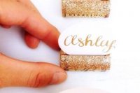 wine corks with gold glitter will be great card holders and such a project is very easy to DIY in a couple of minutes