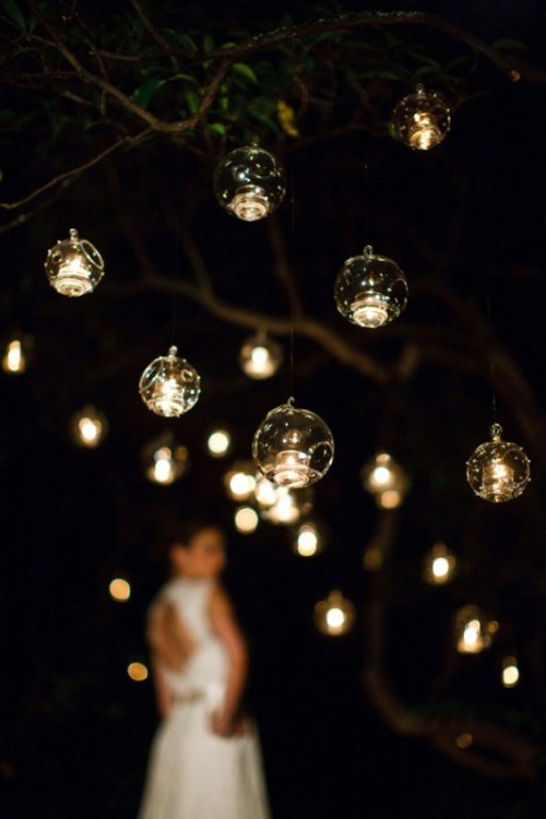 glass bubbles with candles hanging over the reception will give it a magical feel