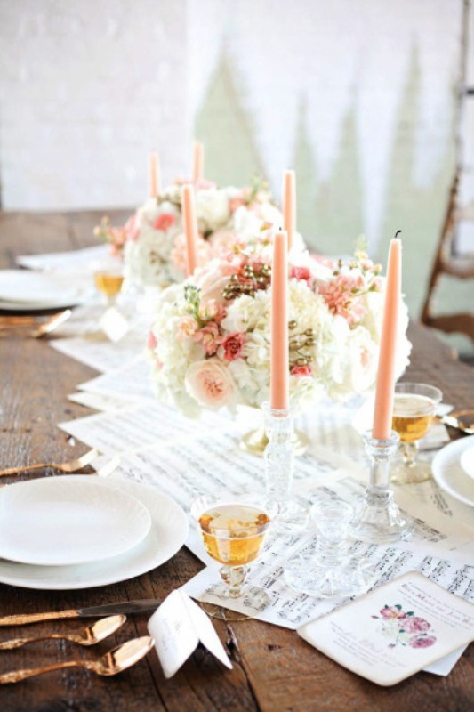 peachy and white blooms and peachy candles create a beautiful wedding tablescape in soft shades