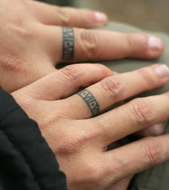 Chic ring imitating tattoos containing your wedding date done in Roman numbers