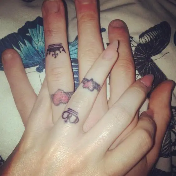 Double wedding ring tattoos of hearts and crowns is a cool idea for two