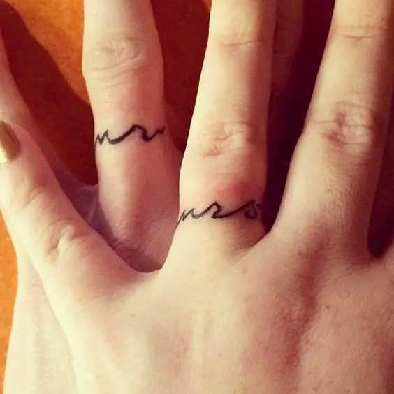 Simple and elegant wedding ring tattoos of curvsive Mr and Mrs are not too much