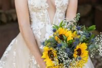 a beautiful wedding bouquet of sunflowers, baby’s breath, thistles and greenery is a chic and bold idea for any summer bride