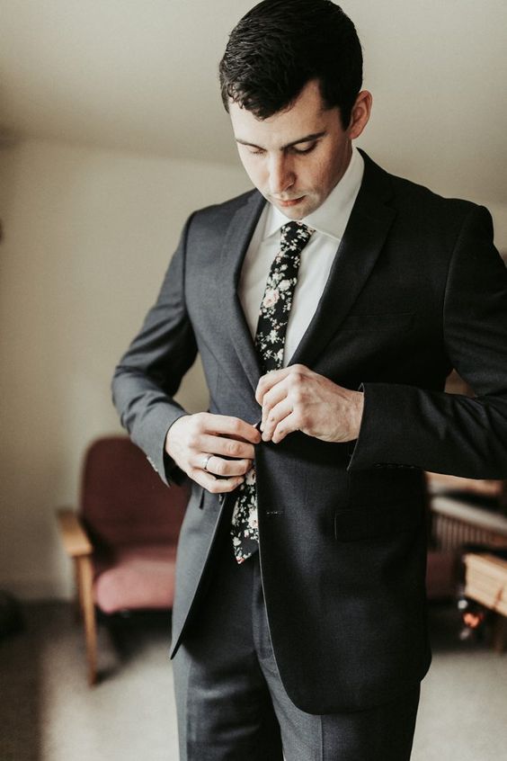 a black pantsuit, a white shirt, a moody floral skinny tie are a nice combo for a summer or fall wedding, can be worn at a winter wedding, too