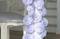a blue paper pompom wedding table runner is a fun and budget-friendly idea for wedding decor