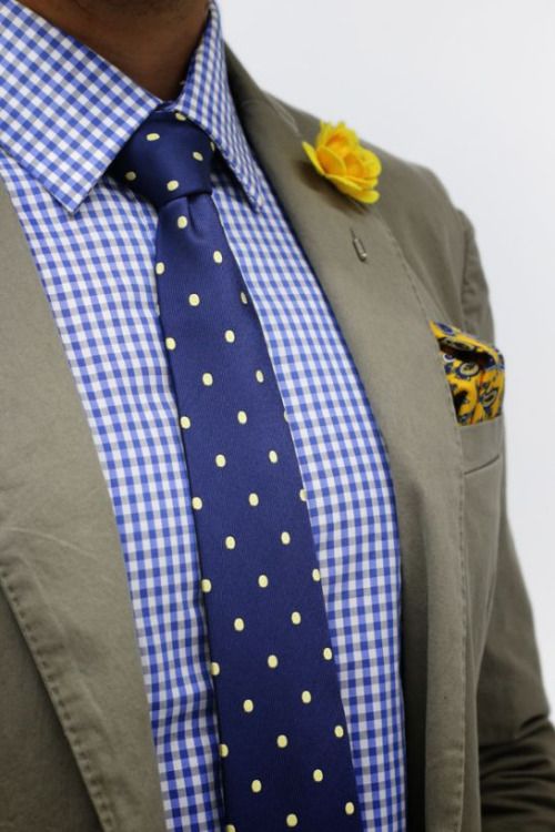 a bold groom's look with a blue checked shirt, a navy and yellow polka dot tie, a yellow boutonniere and a handkerchief