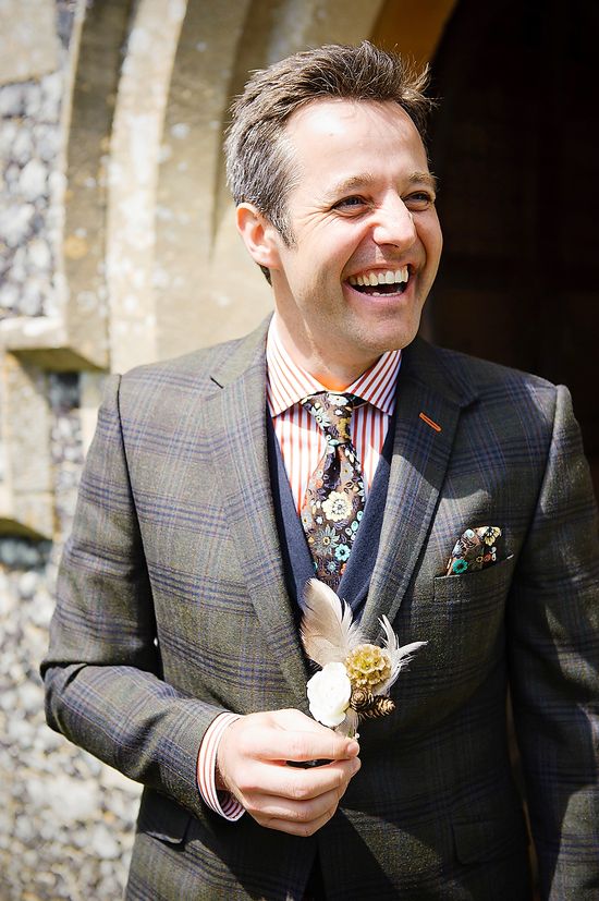 a bold mismatched groom's look with a red striped shirt, a moody floral tie, a navy waistcoat and a checked blazer is amazing