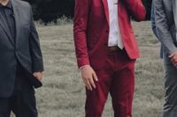 a bold red suit, a white shirt, a white tie and brown shoes for a bright fall look that stands out