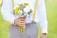 a bold spring groom’s look with a white shirt, a yellow printed bow tie and matching suspenders plus grey pants