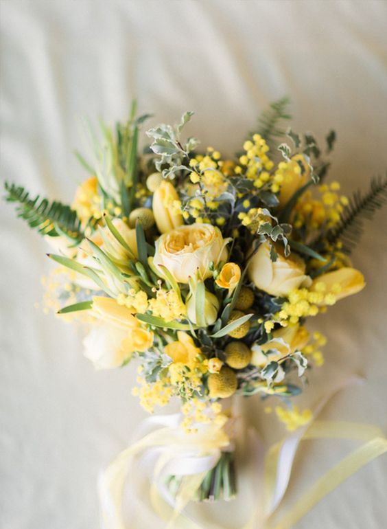 a bold yellow wedding bouquet of peony roses, tulips, billy balls, mimosas and greenery is an amazing idea for spring