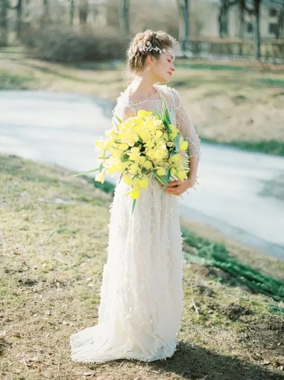 a bold yellow wedding bouquet with greenery is a bright accent to highlight your wedding look
