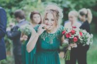 a bridesmaid dress in emerald with a faux strapless neckline, a lace bodice and a pleated skirt