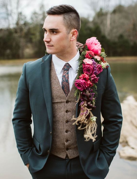 a bright boho groom's look with a white shirt, a brown waistcoat, a grey blazer, a printed tie and bright blooms instead of a boutonniere
