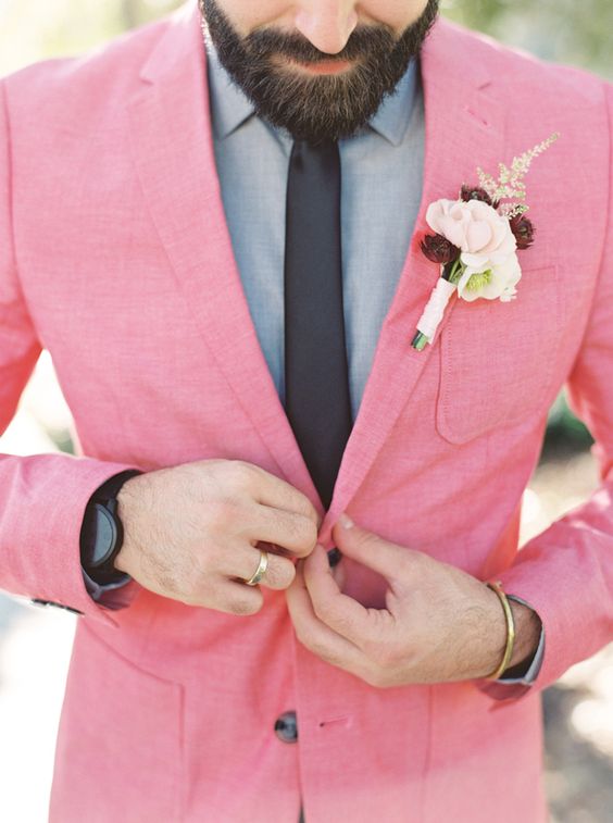 a bright pink blazer, a grey shirt and a blakc tie for a bold and unique summer groom's look