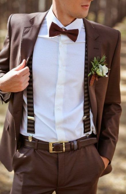 a brown suit, a white shirt, brown printed suspenders and a floral boutonniere for a fall groom's look