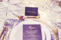 a chic purple and gold wedding tablescape with lush neutral florals