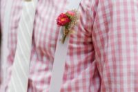 a colorful rustic summer look with a printed plaid shirt, a creamy striped tie, creamy suspenders and a bright boutonniere