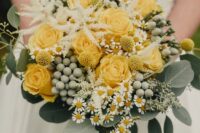 a cool yellow rose wedding bouquet with berries, chamomiles, greenery and some astilbe will work for spring or summer