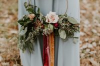 a floral hoop with colorful velvet ribbons that doubles as a non-traditional bouquet