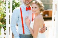 a fun summer groom’s look with a blue shirt, red suspenders, a red bow tie and grey pants is outstanding