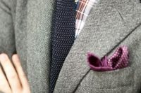 a grey tweed blazer, a checked shirt, a black tie and a purple polka dot handkerchief for a stylish and more casual wedding look