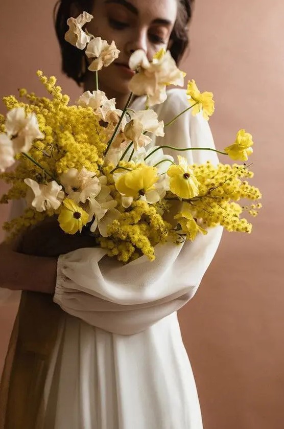 a lush and refined yellow and neutral wedding bouquet with much dimension is a bold solution