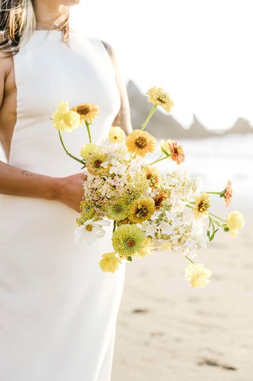 a modern coastal wedding bouquet in yellow, with smaller neutral fillers is a stylish idea to try