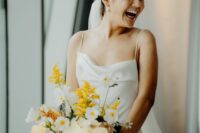 a modern wedding bouquet with yellow orchids, mimosas, white blooms is a gorgeous idea for a chic modern wedding