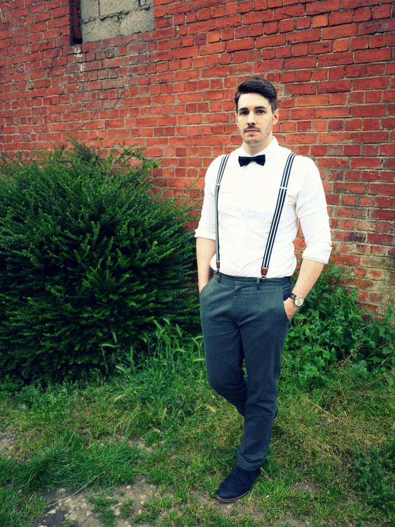 a monochromatic look with a white shirt, striped suspenders, a black bow tie and grey pants