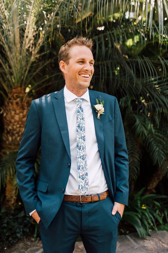 a navy pantsuit, a white shirt, a floral skinny tie are a nice and chic combo for a fall or tropical wedding, a floral print brings interest to the look