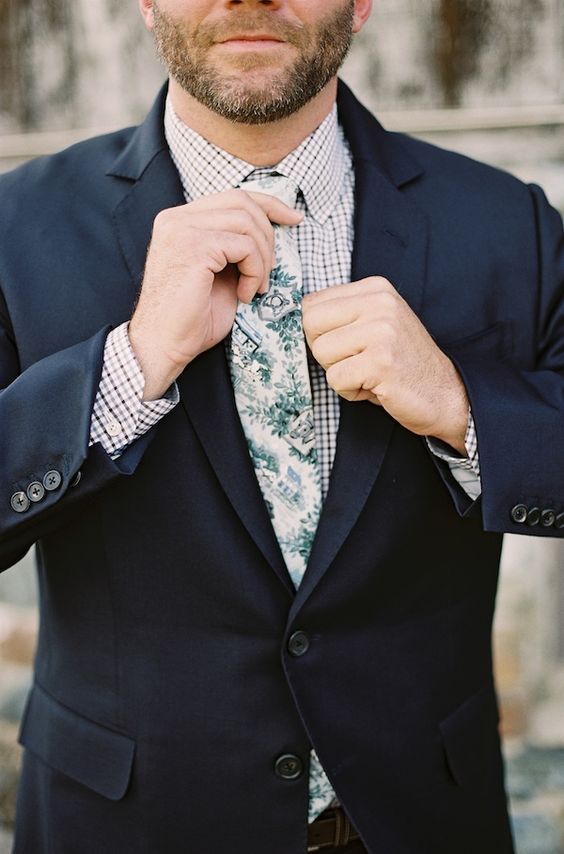 a navy suit, a gingham shirt, a botanical print tie for a stylish and cool look with a bit of print