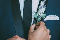 a navy tuxedo with black lapels, a white shirt, a black skinny tie and a pretty blooming boutonniere are an amazing idea for a wedding