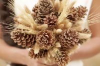 a pinecone and wheat wedding bouquet is ideal for a rustic bride, it’s very cozy and cool